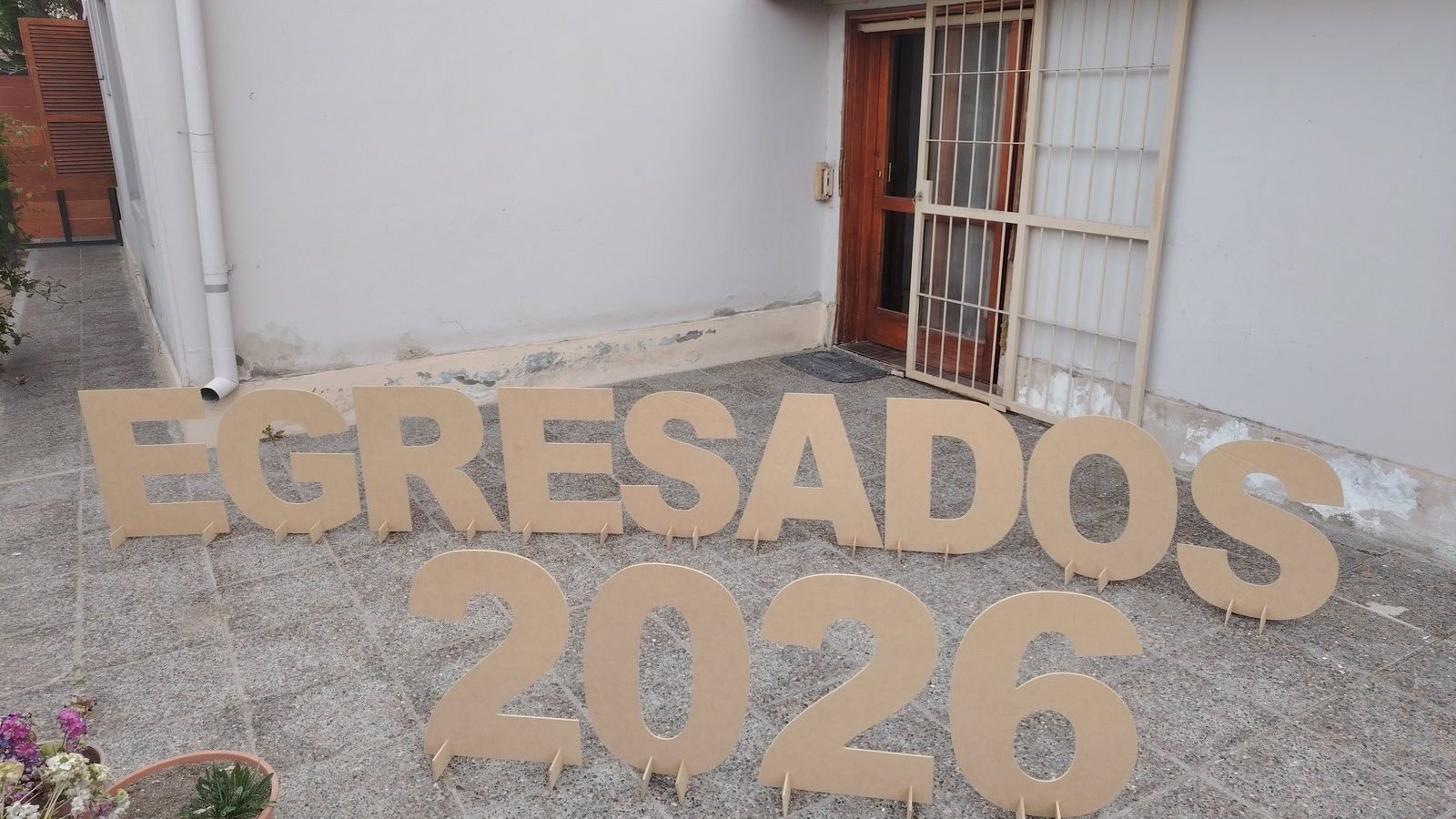 Letras corpóreas EGRESADOS 2026 de pie en un patio, cortadas con router CNC en nuestro taller de General Roca
